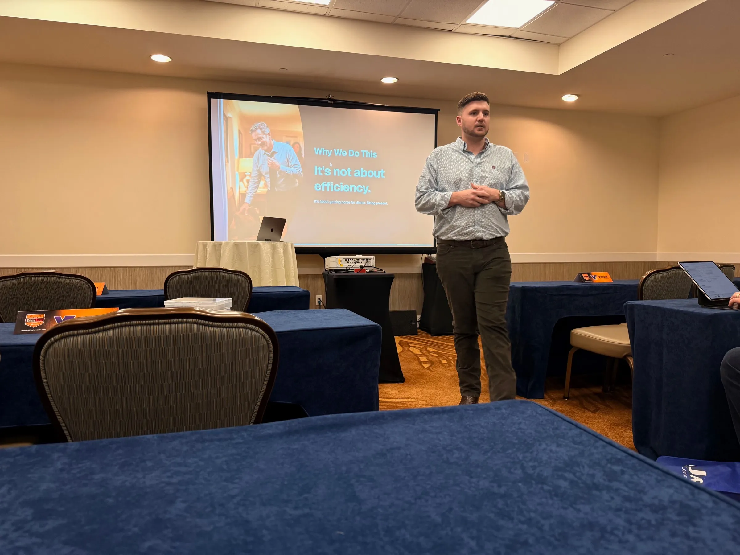 Matthew Henry presenting a slide reading: It's not about efficiency